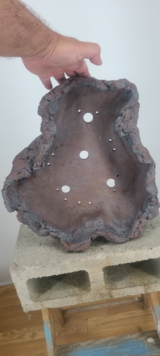 Senor Square rock pot held for scale, showing interior and drainage